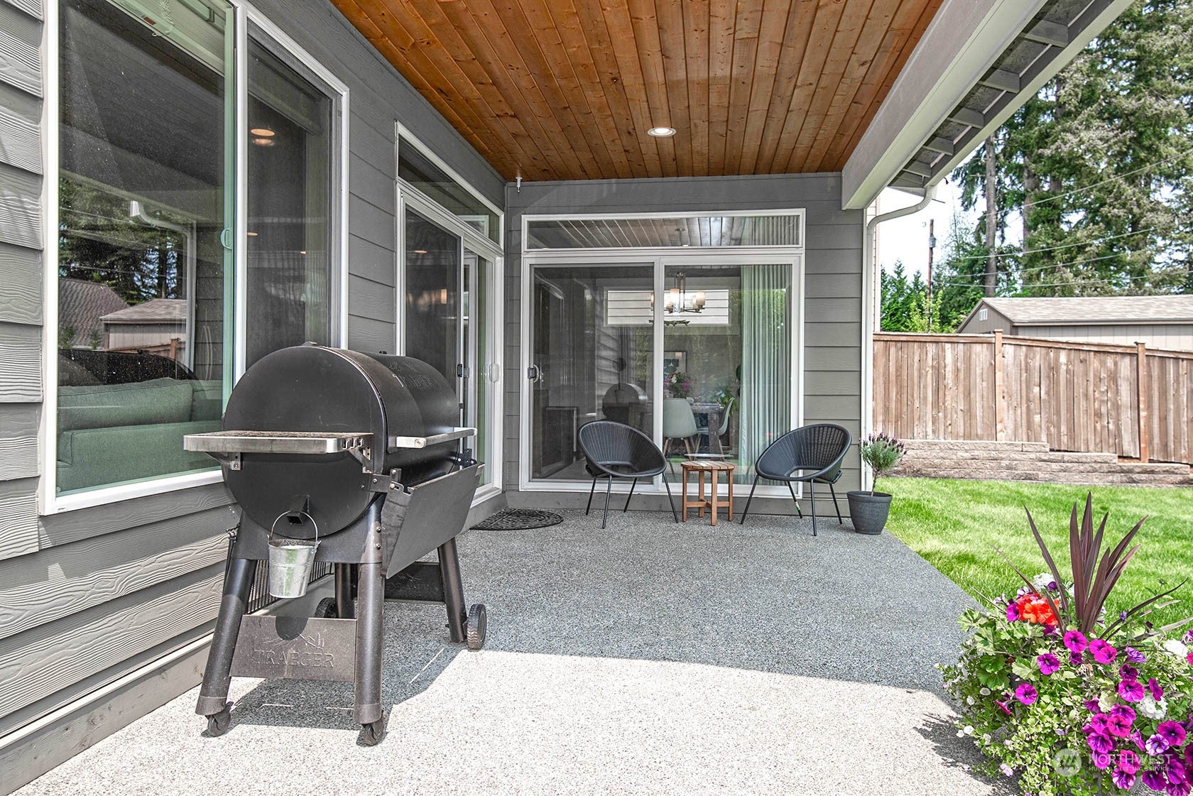 21127 35th Drive Southeast Bothell, WA 98021 - Photo 36 of 40 a view of a patio with table and chairs and wooden fence with potted plants