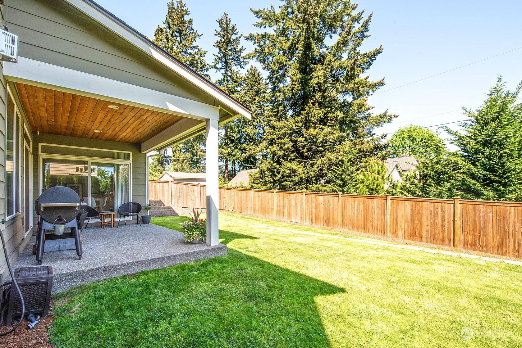 21127 35th Drive Southeast Bothell, WA 98021 - Photo 38 of 40 a view of a backyard with table and chairs and wooden fence