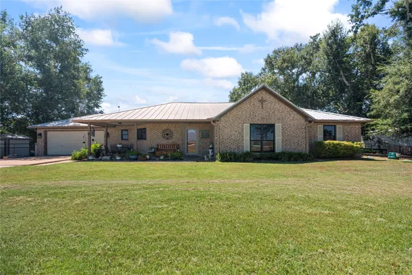 a front view of house with yard and green space