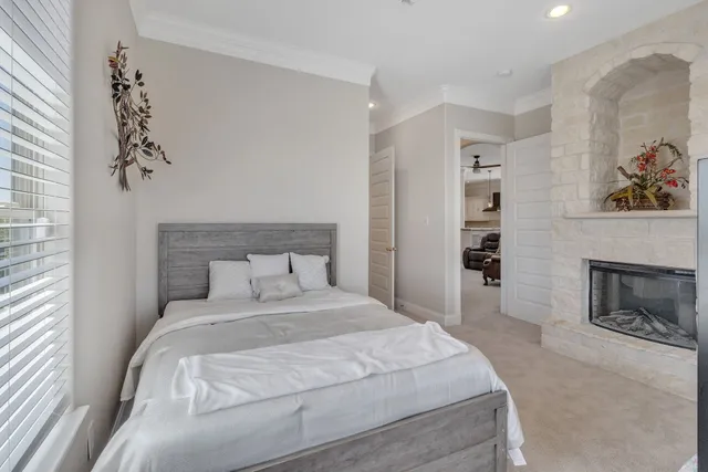 a bedroom with bed and a large window