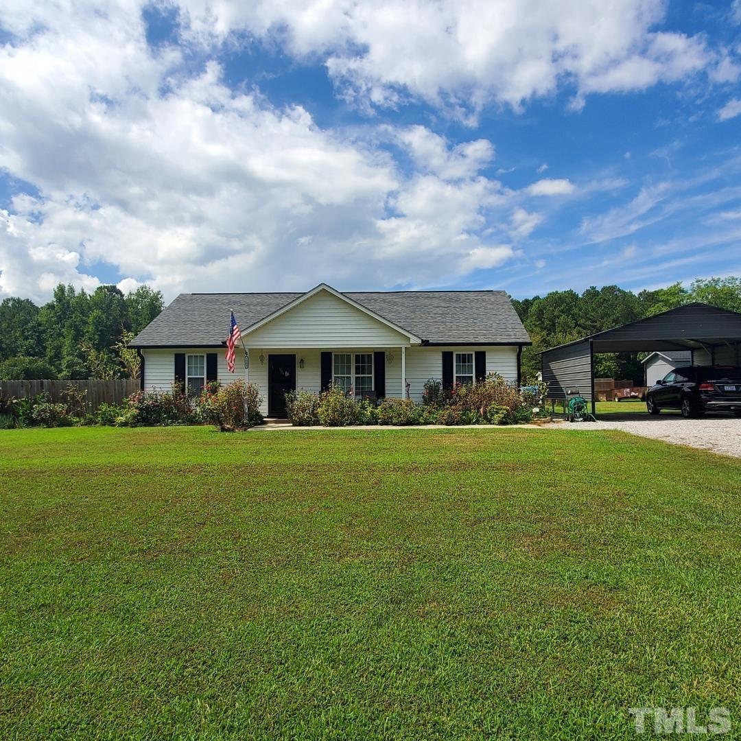 1283 Lee Road Clayton, NC 27520 - Photo 1 of 32 a front view of a house with a garden