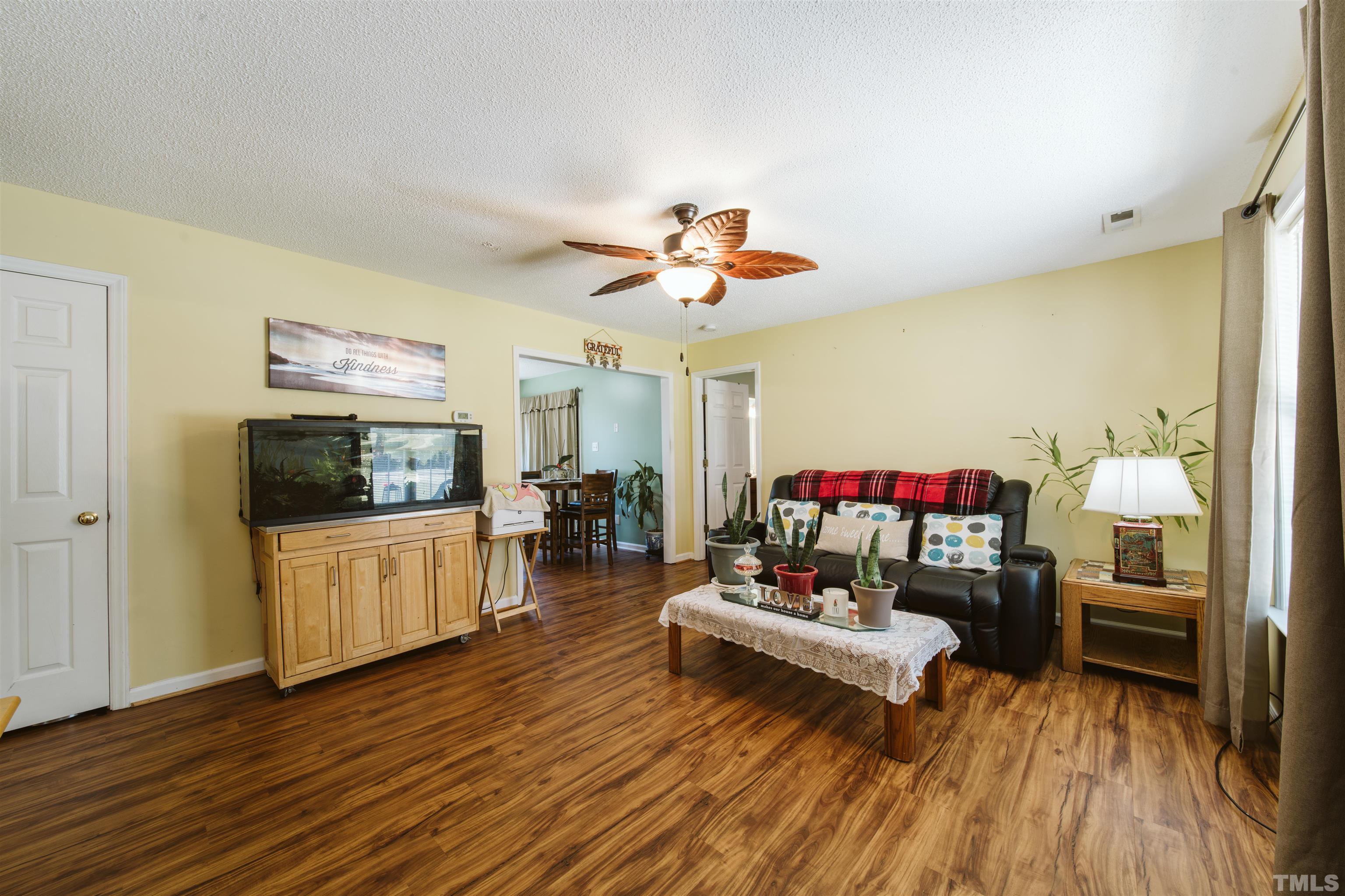 1283 Lee Road Clayton, NC 27520 - Photo 17 of 32 a living room with furniture and a flat screen tv