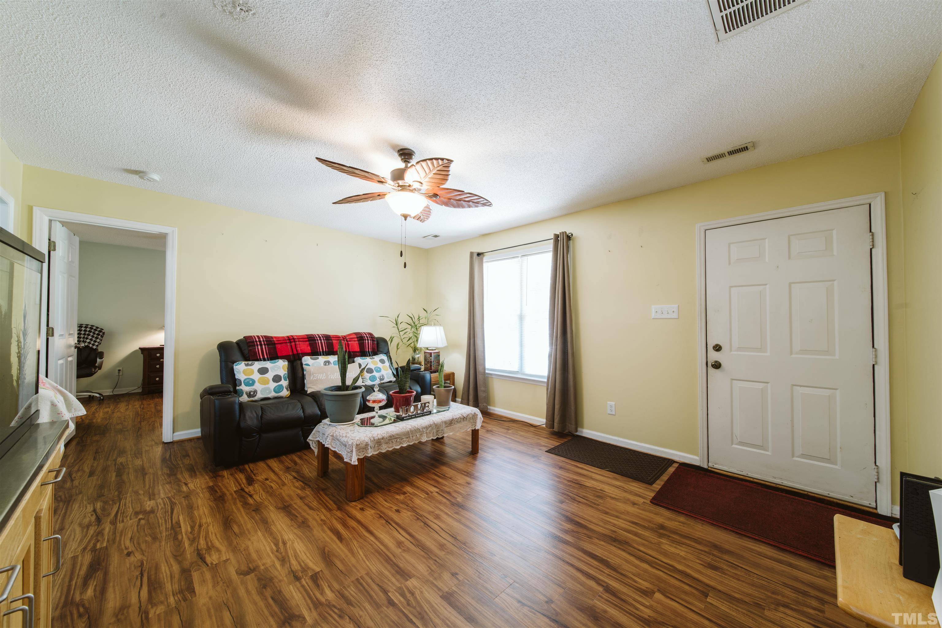 1283 Lee Road Clayton, NC 27520 - Photo 18 of 32 a living room with furniture and a wooden floor