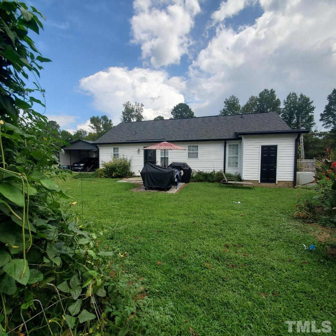 1283 Lee Road Clayton, NC 27520 - Photo 2 of 32 a front view of a house with a garden