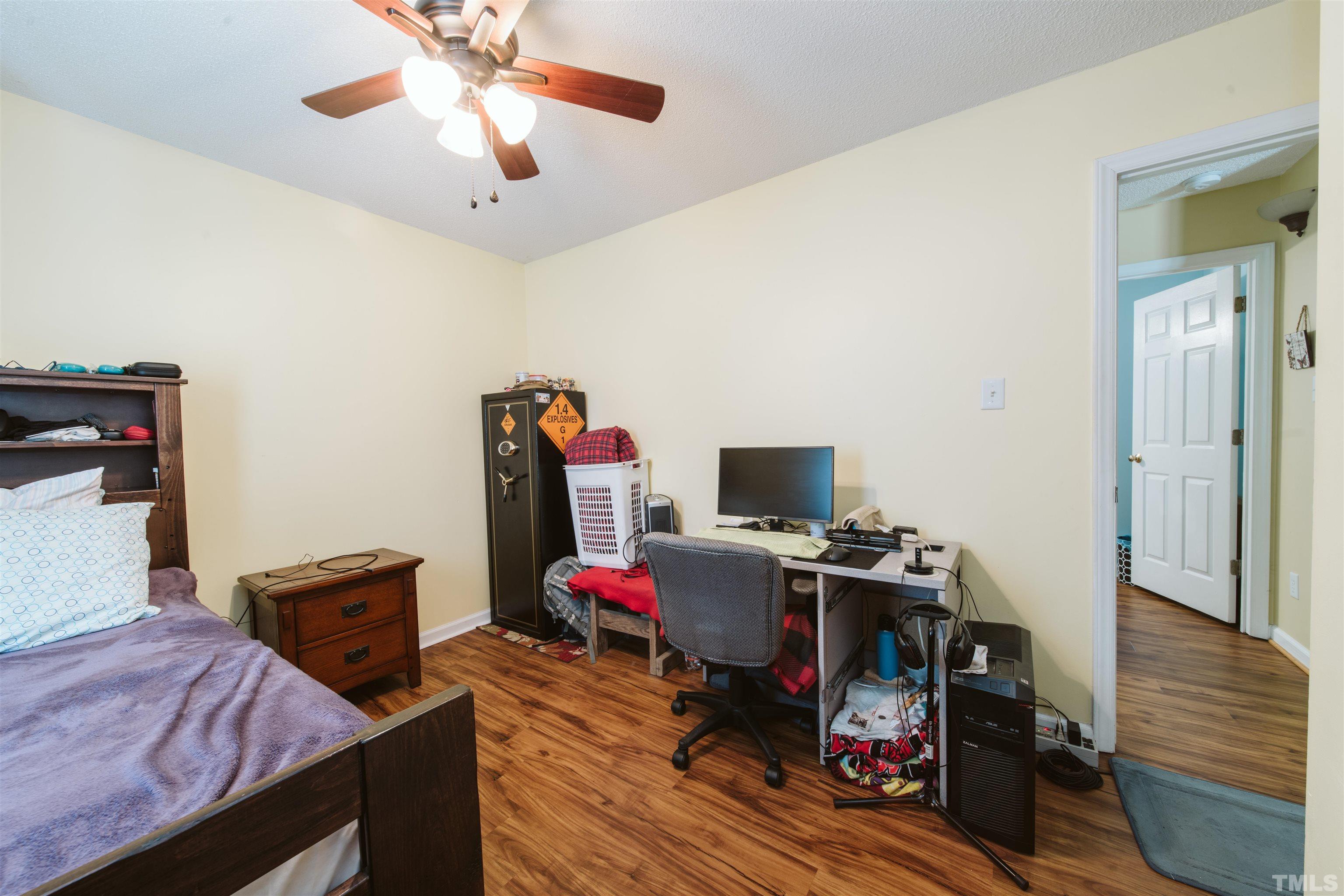 1283 Lee Road Clayton, NC 27520 - Photo 23 of 32 a bedroom with a bed and wooden floor