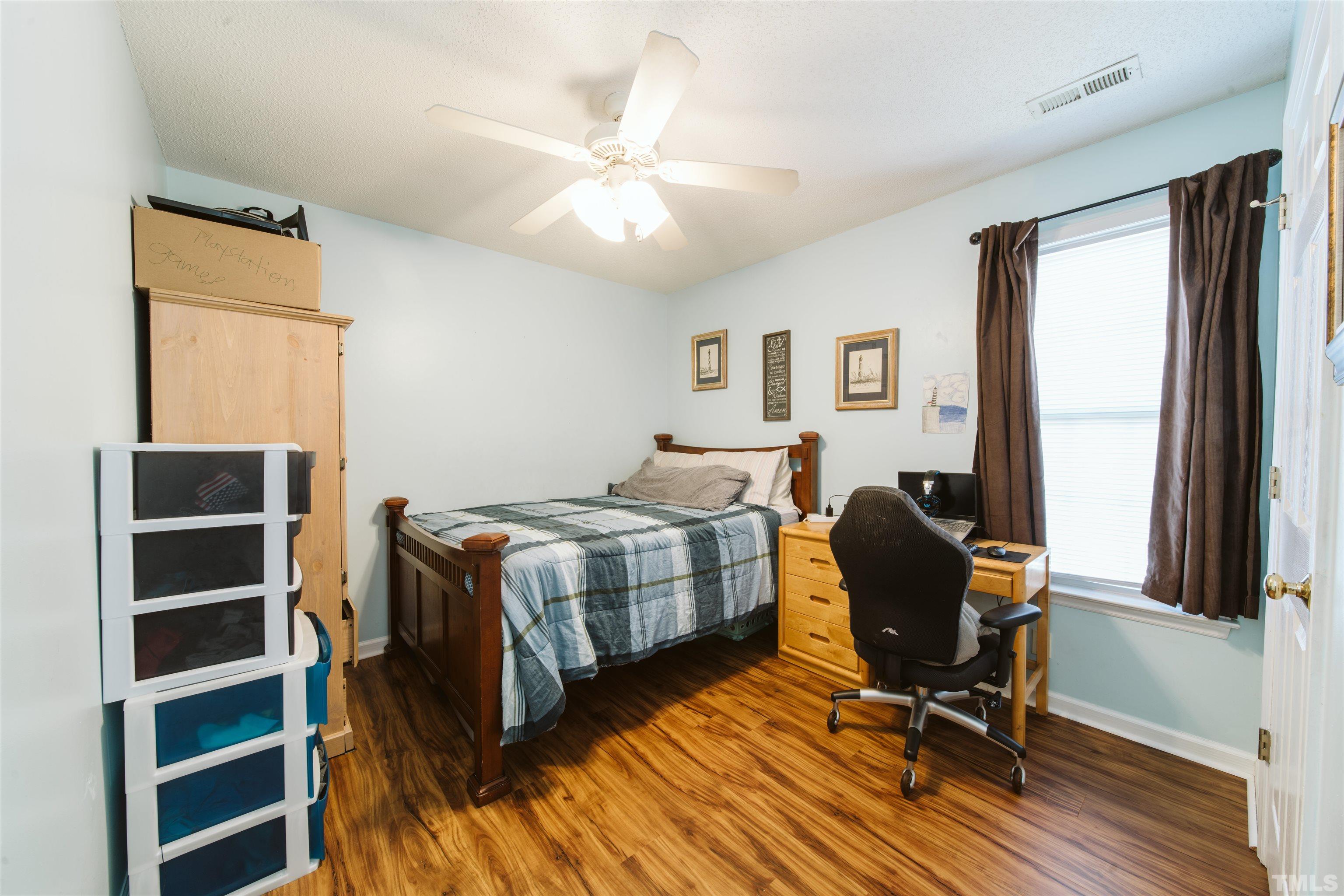 1283 Lee Road Clayton, NC 27520 - Photo 24 of 32 a bedroom with a bed and a window
