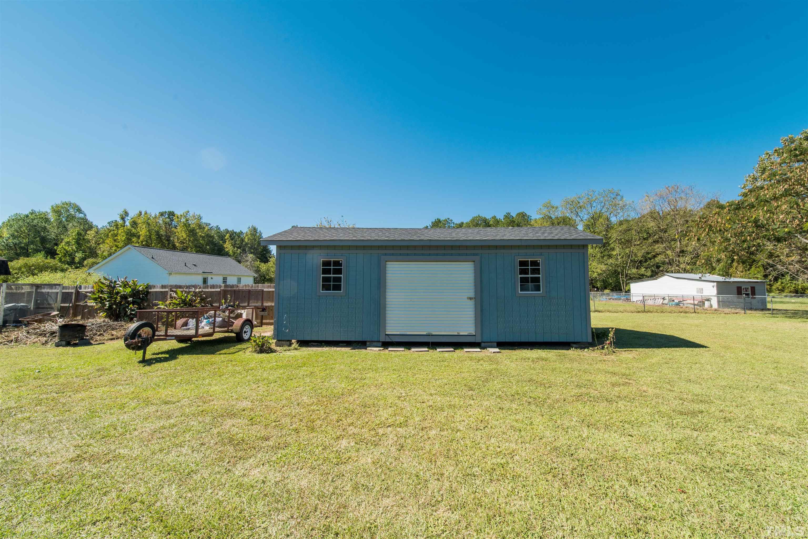 1283 Lee Road Clayton, NC 27520 - Photo 32 of 32 a view of a house with a yard and sitting area