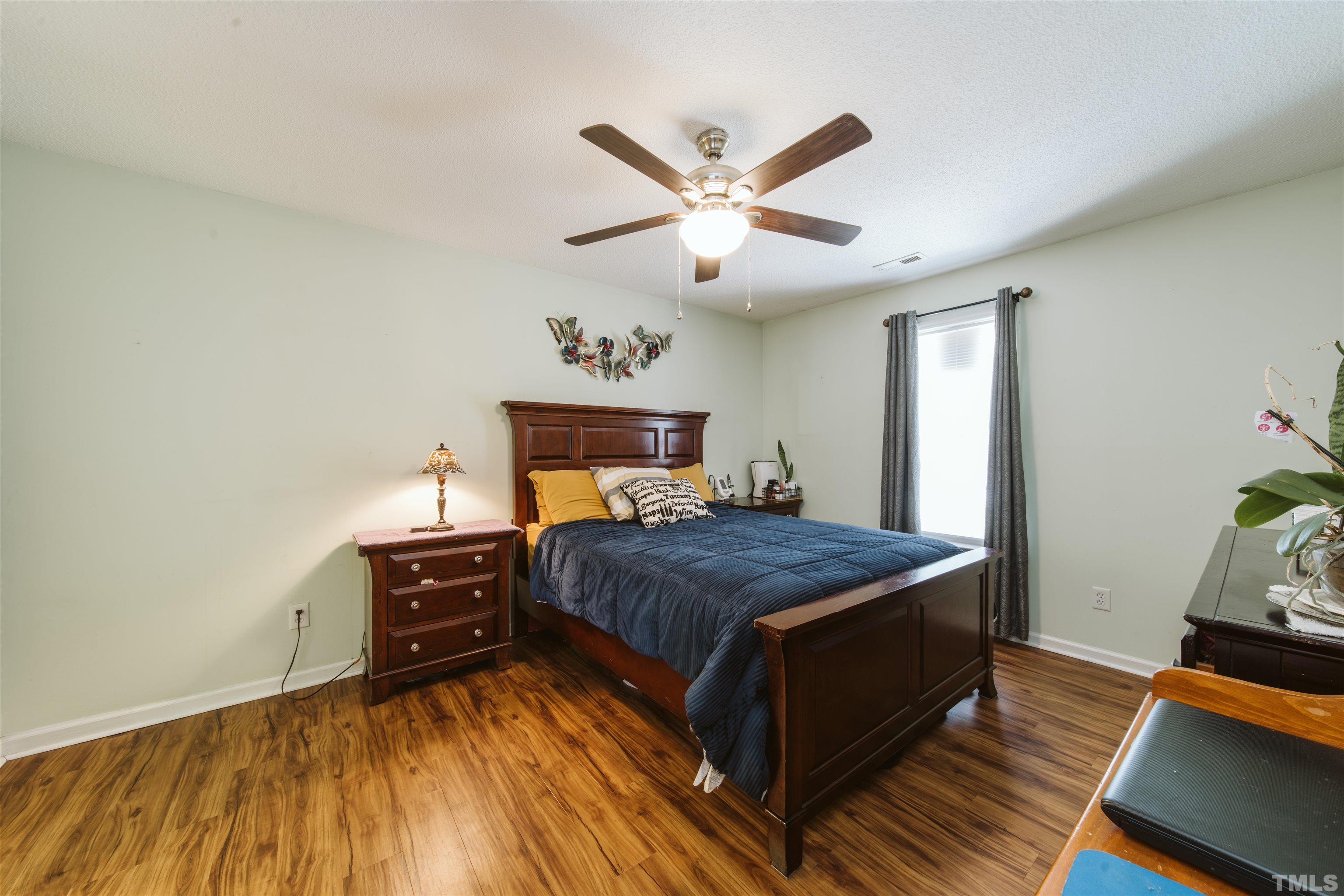 1283 Lee Road Clayton, NC 27520 - Photo 7 of 32 a bedroom with a bed and wooden floor