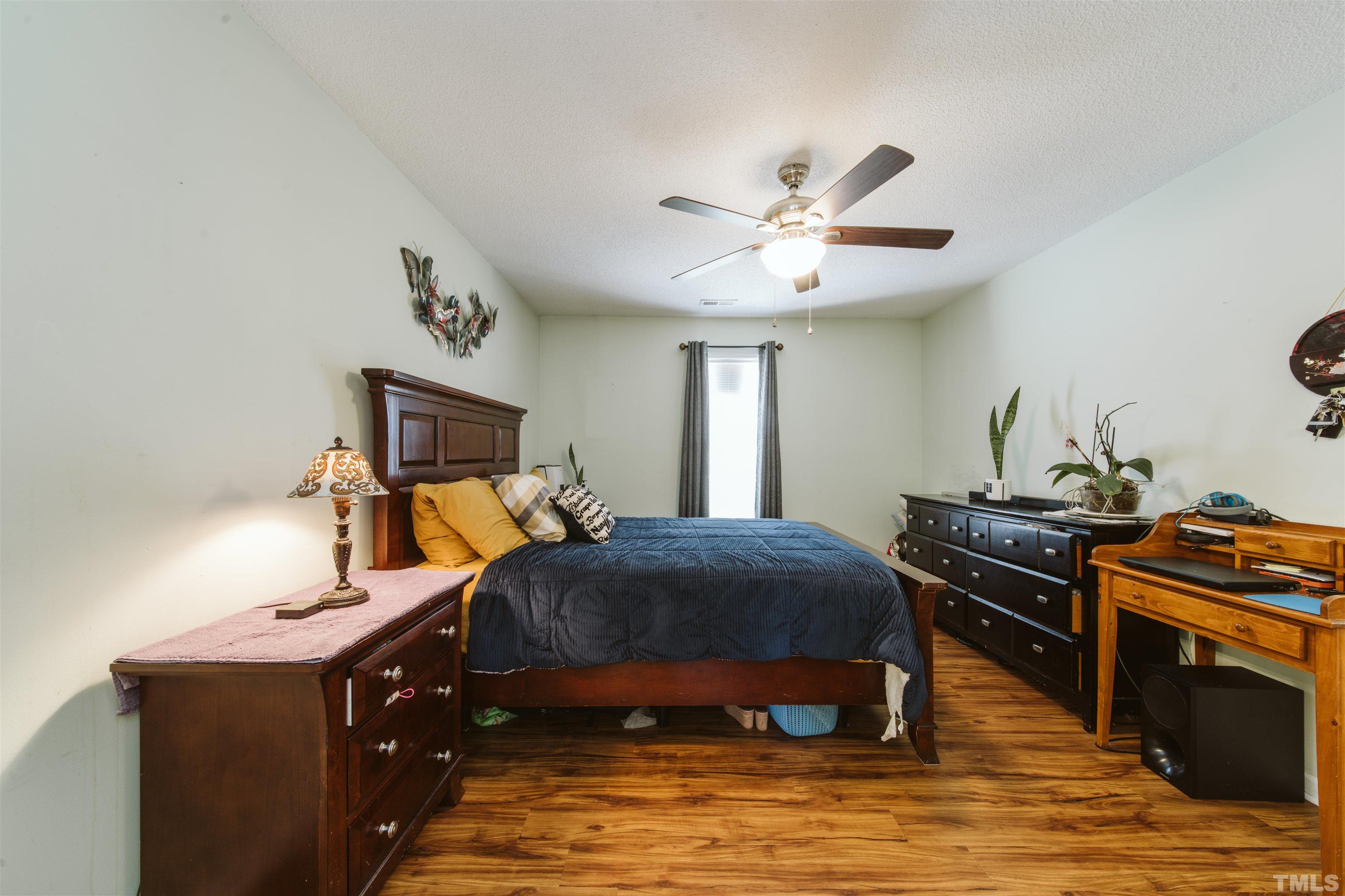 1283 Lee Road Clayton, NC 27520 - Photo 8 of 32 a bedroom with a bed and a chandelier