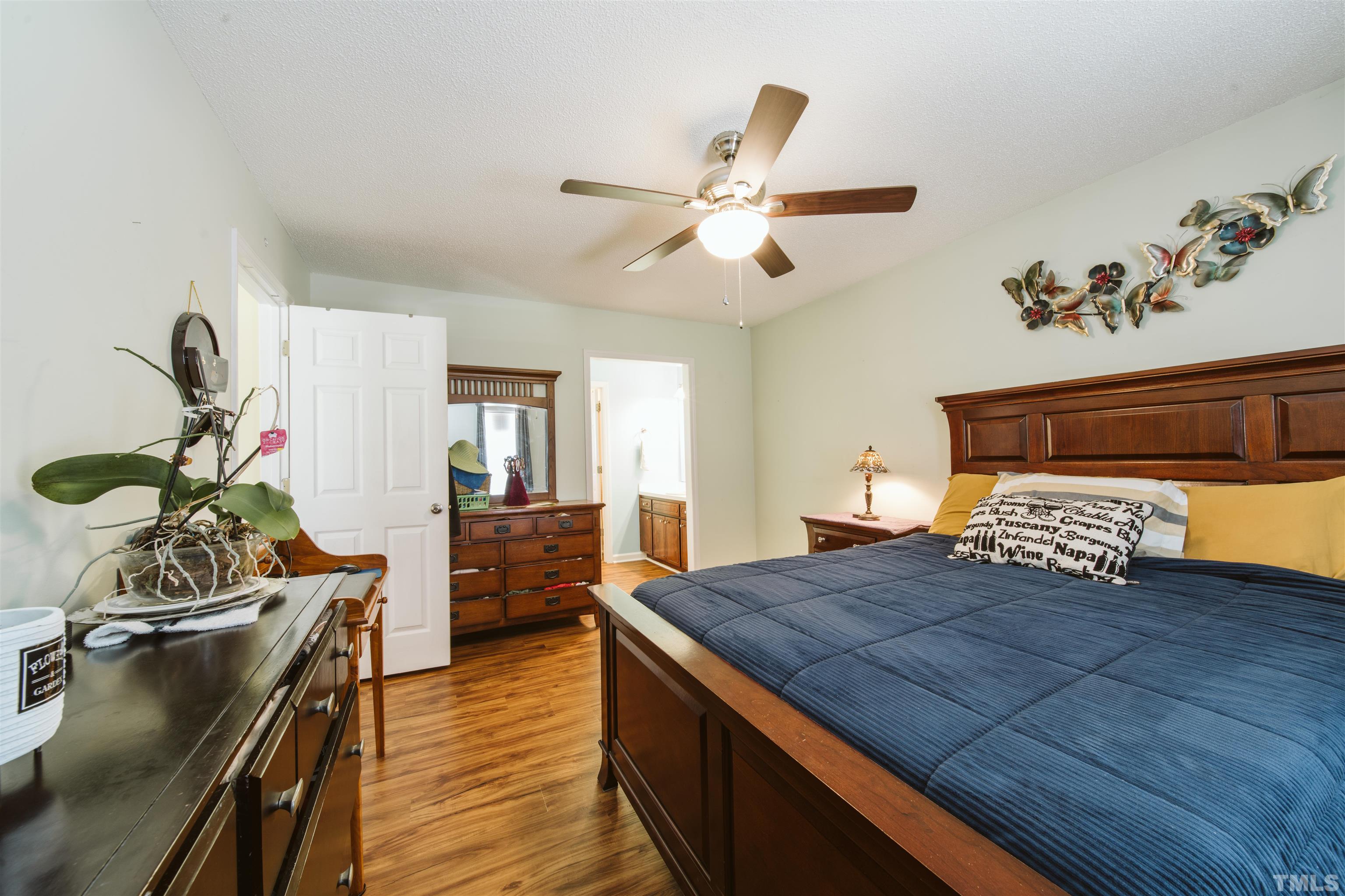 1283 Lee Road Clayton, NC 27520 - Photo 9 of 32 a bedroom with a bed and wooden floor