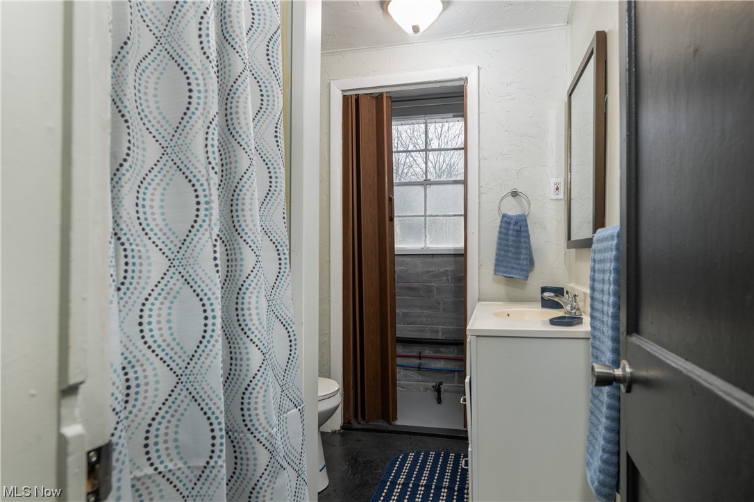 6273-6275 Manchester Road Clinton, OH 44216 - Photo 12 of 27 Bathroom featuring oversized vanity and toilet
