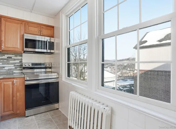 a kitchen with stainless steel appliances a stove and a microwave