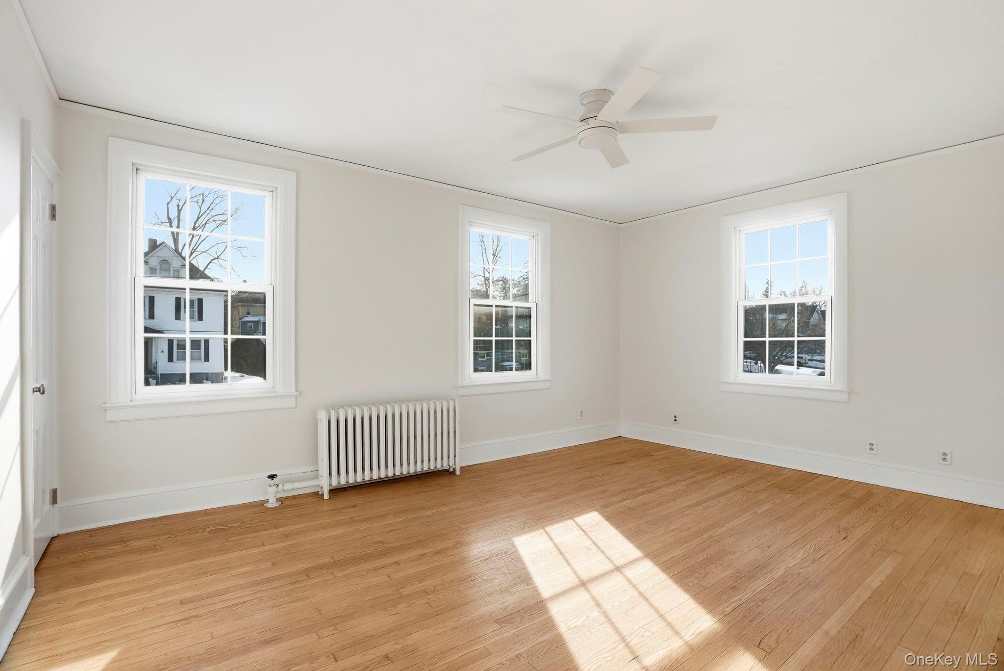 320 Simpson Place Peekskill, NY 10566 - Photo 12 of 18 a view of an empty room with a window and wooden floor