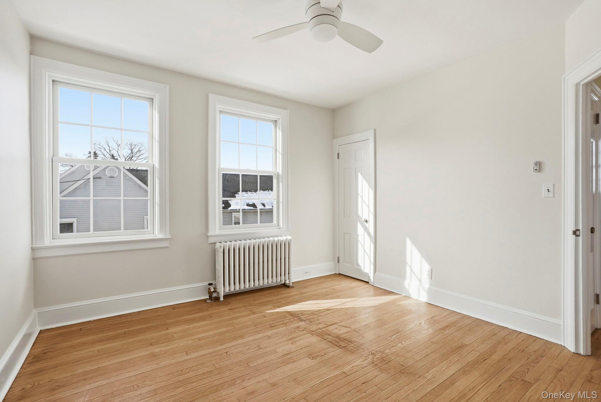 320 Simpson Place Peekskill, NY 10566 - Photo 14 of 18 a view of empty room with wooden floor and fan