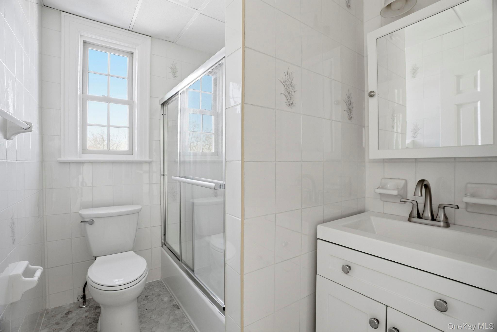 320 Simpson Place Peekskill, NY 10566 - Photo 16 of 18 a bathroom with a toilet sink and mirror
