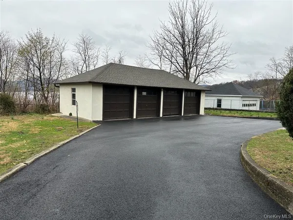 a view of a house with a yard and garage