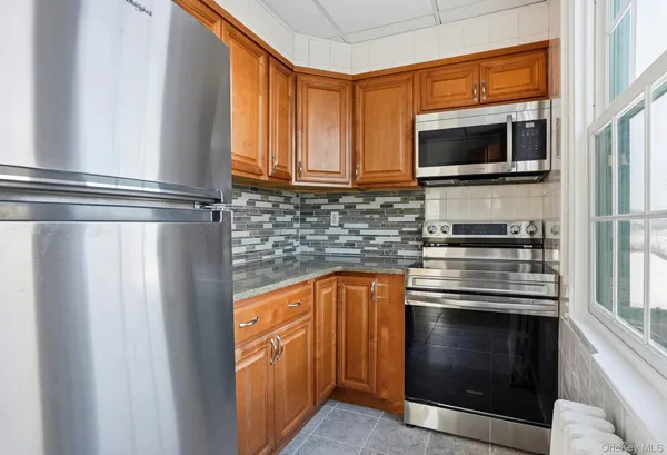 a kitchen with stainless steel appliances granite countertop a stove and a microwave