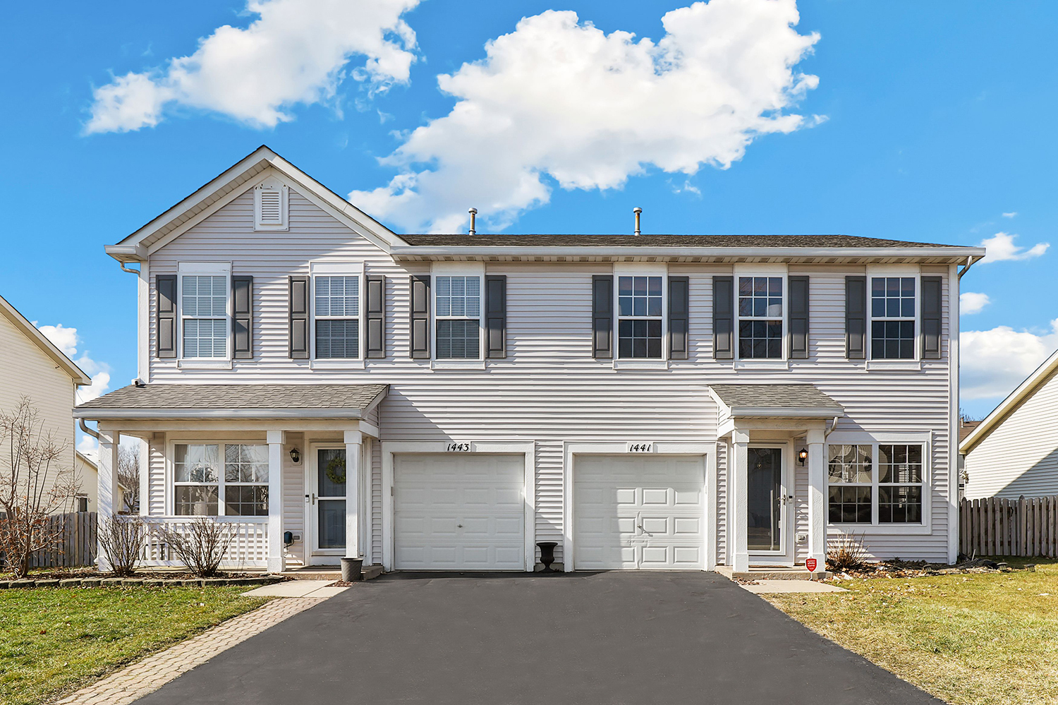 1441 Red Top Lane Minooka, IL 60447 - Photo 1 of 24 a view of a white house with large windows and a yard