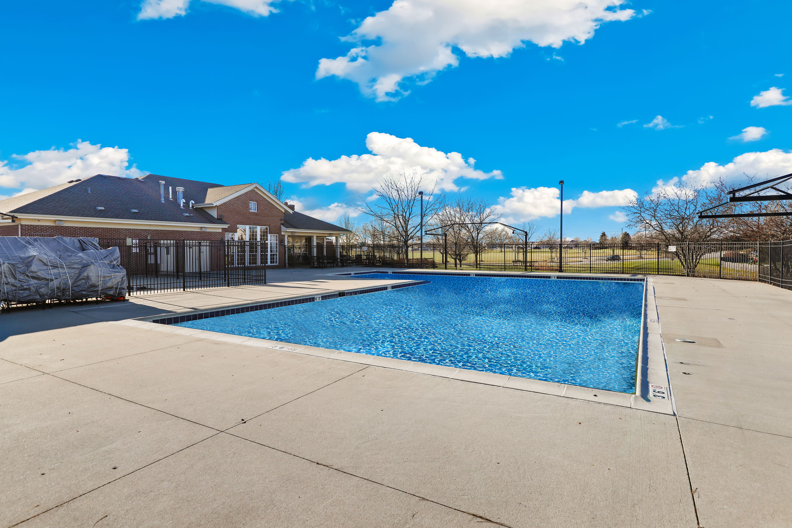 1441 Red Top Lane Minooka, IL 60447 - Photo 21 of 24 a view of a swimming pool with a table under an umbrella
