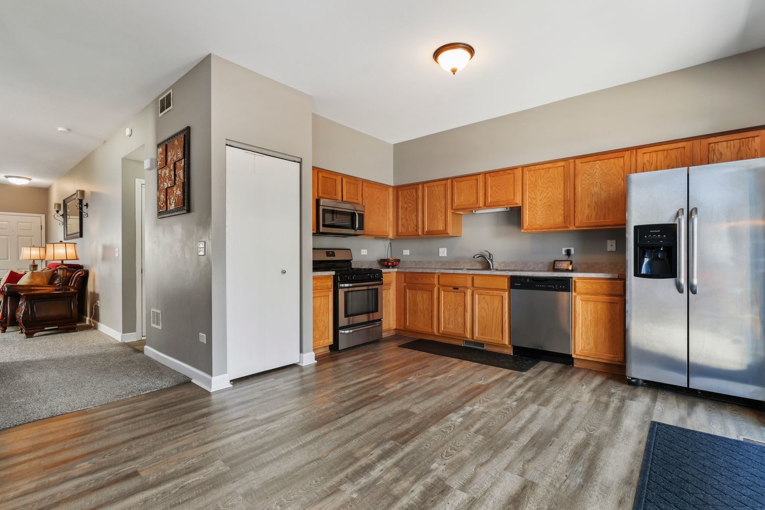1441 Red Top Lane Minooka, IL 60447 - Photo 7 of 24 a kitchen with granite countertop stainless steel appliances and wooden cabinets