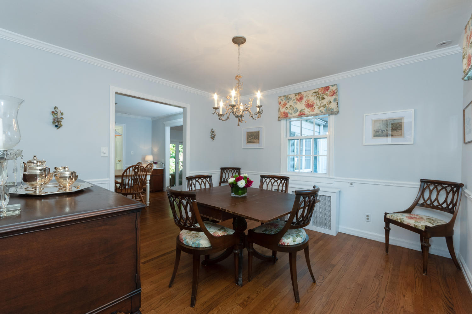 6 Miles Road Darien, CT 06820 - Photo 8 of 31 a dining room with furniture a chandelier and wooden floor