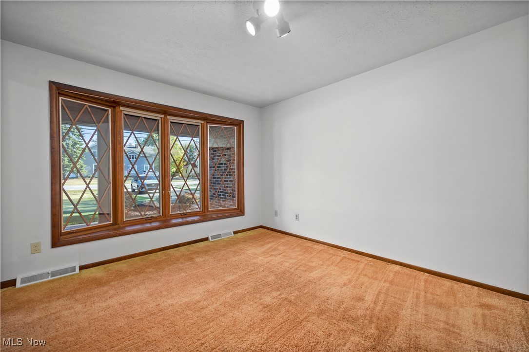 1711 Gulf Road Elyria, OH 44035 - Photo 22 of 50 Carpeted empty room with baseboards and a textured ceiling