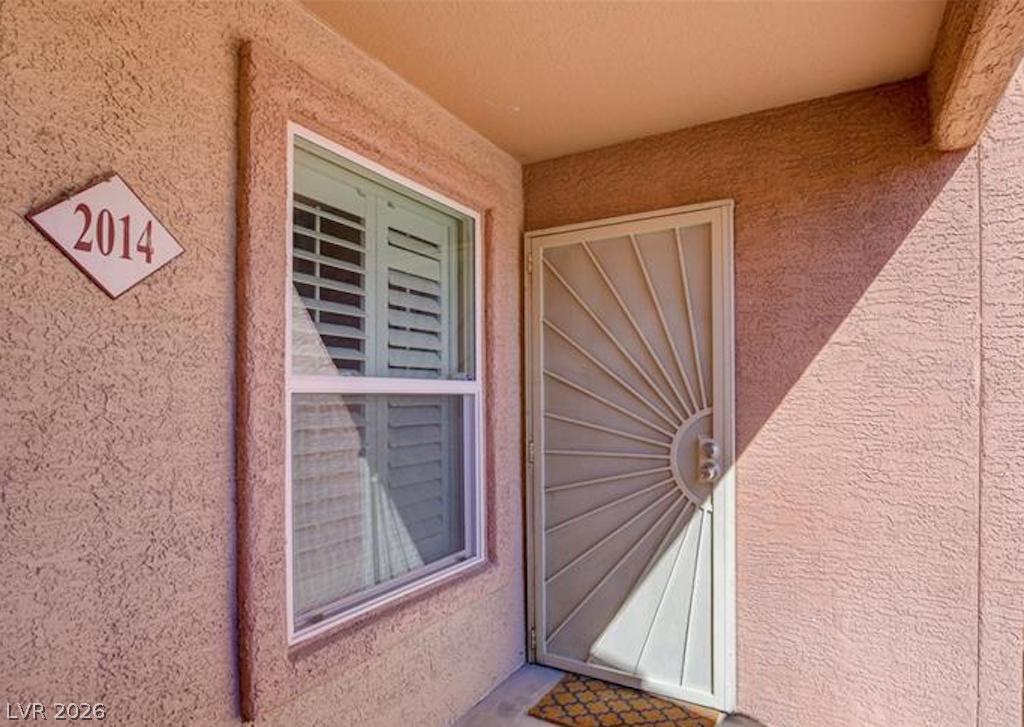 8101 West Flamingo Road, Unit 2014 Las Vegas, NV 89147 - Photo 9 of 13 A stucco exterior and gated security door define this inviting private entry.