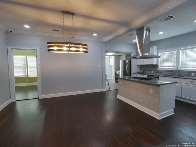 a view of kitchen with cabinets and wooden floor