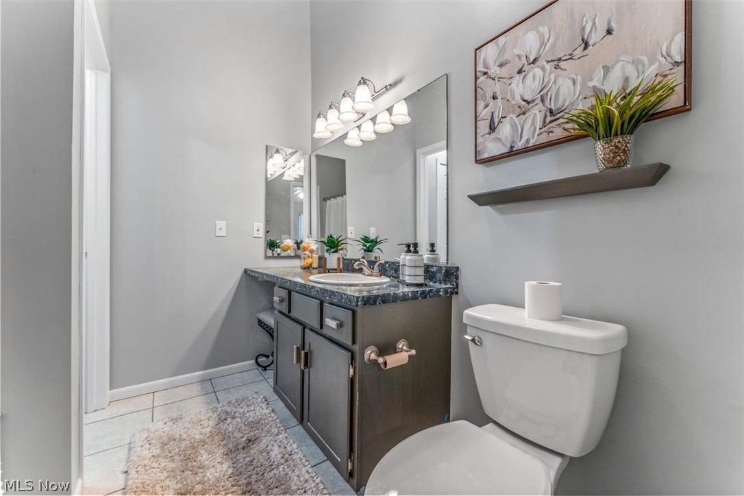 6907 Tippecanoe Road, Unit 1 Canfield, OH 44406 - Photo 14 of 26 SPACIOUS FULL BATH INCLUDES REFINISHED VANITY AND COUNTERTOP, JETTED TUB, CERAMIC TILE FLOORING, NEWER LIGHT FIXTURES, VAULTED CEILING AND MORE!
