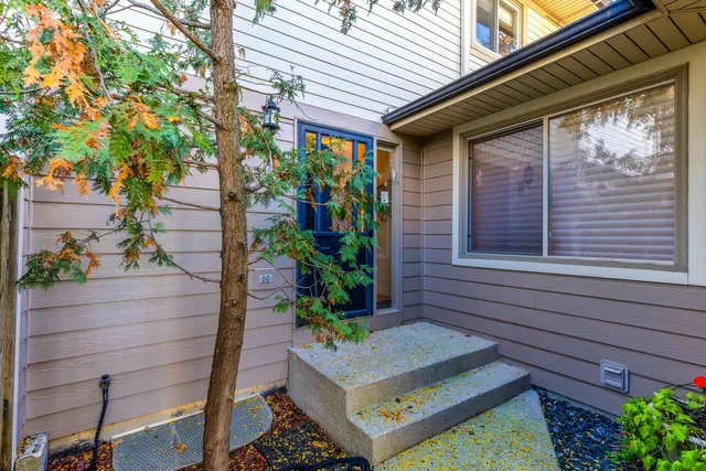 a wooden bench sitting in front of a house