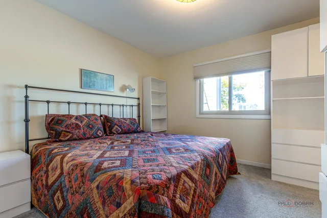 a bedroom with a large bed and a window