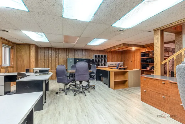 a kitchen with stainless steel appliances kitchen island granite countertop a sink dishwasher stove and refrigerator with wooden floor