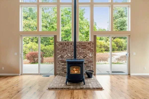 a living room with a fireplace and a floor to ceiling window