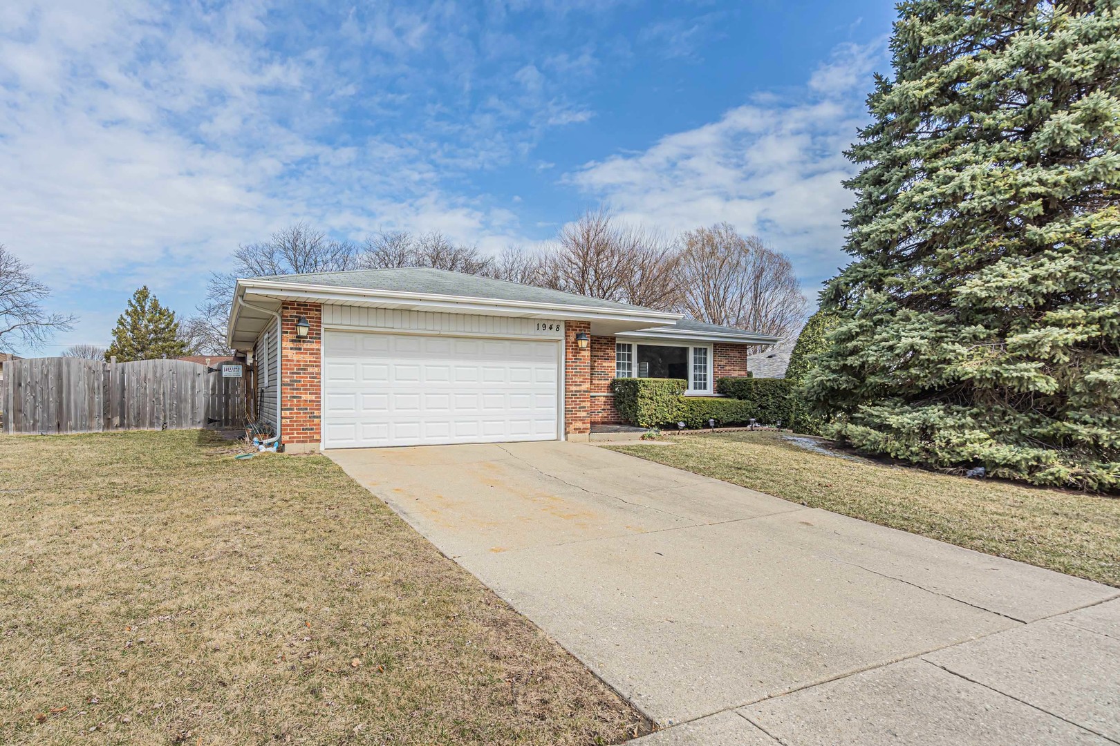 1948 West Spring Ridge Drive Arlington Heights, IL 60004 - Photo 1 of 21 a front view of house with yard and trees in the background
