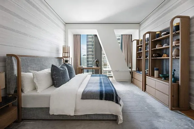 a spacious bedroom with a bed and walk in closet