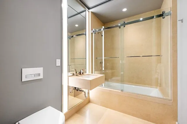 a bathroom with a shower and a bath tub