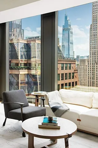 a living room with furniture and a floor to ceiling window