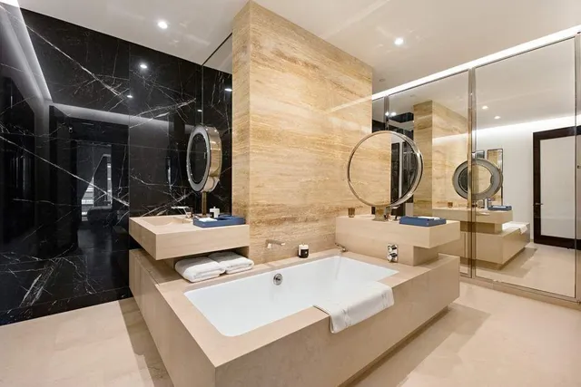 a bathroom with a double vanity sink and a mirror