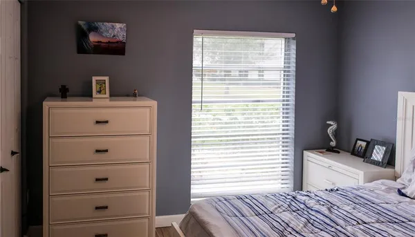a view of bedroom with furniture and large window