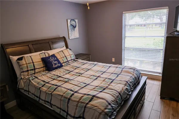 a bedroom with a bed and a window