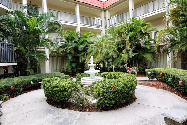 a front view of a multi story building with yard