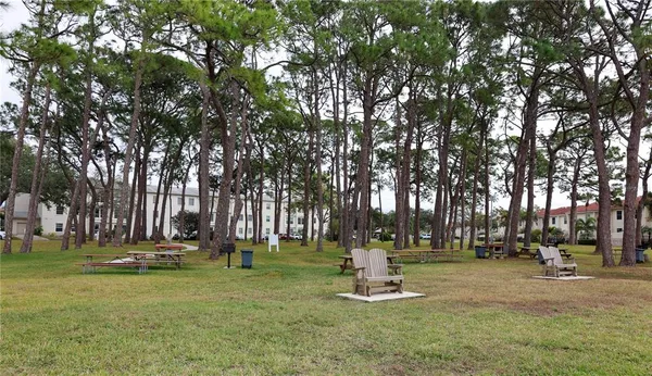 a view of a yard with wooden fence
