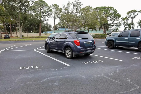 a view of a workspace with furniture and a bookshelf
