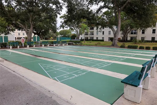 a room with furniture pool table and wooden floor