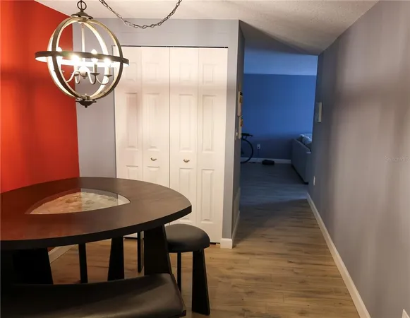 a room with a table and chandelier