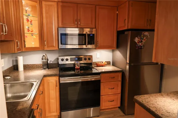 a kitchen with a refrigerator stove and microwave