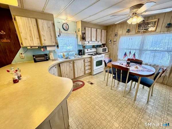 a kitchen with a table chairs and a refrigerator