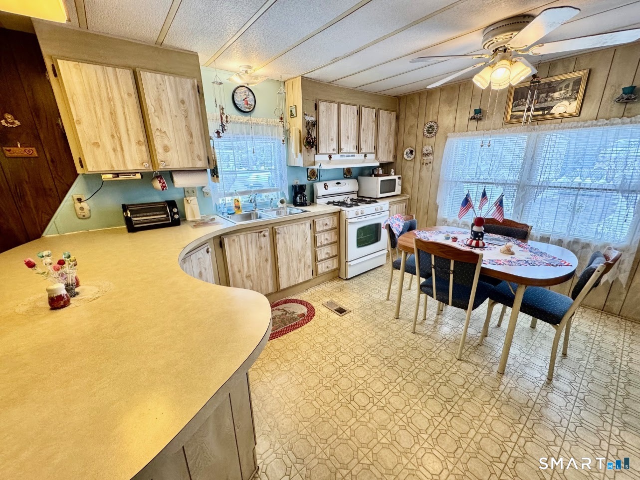 1070 Amity Road Bethany, CT 06524 - Photo 1 of 14 a kitchen with a table chairs and a refrigerator