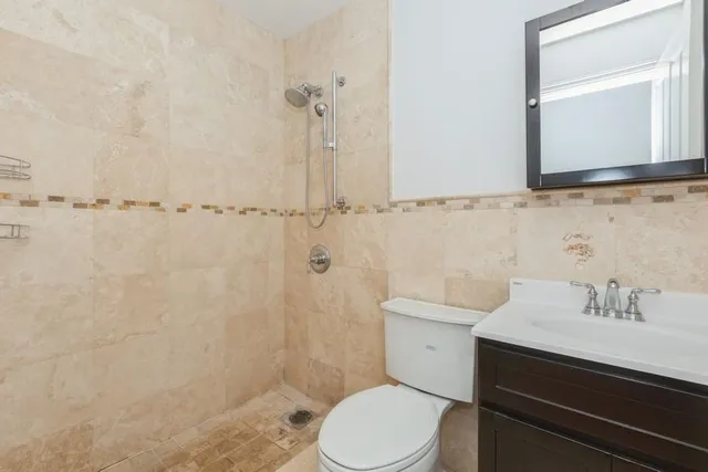 a bathroom with a toilet a sink and mirror