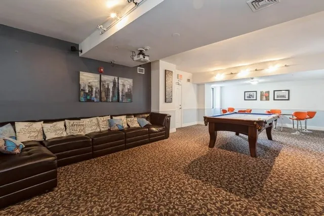 a living room with furniture a rug and a window